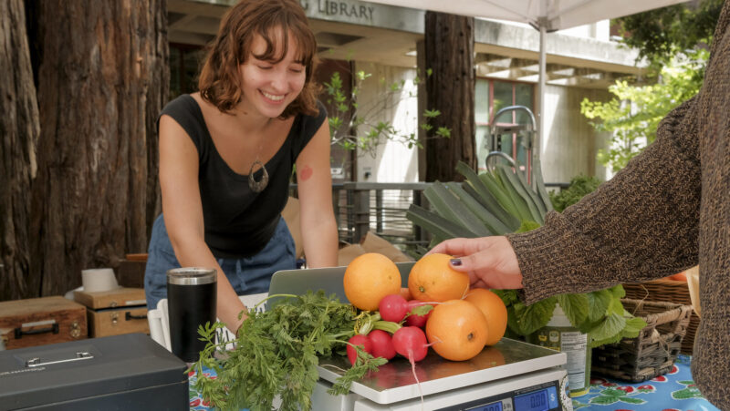 person weighing produce