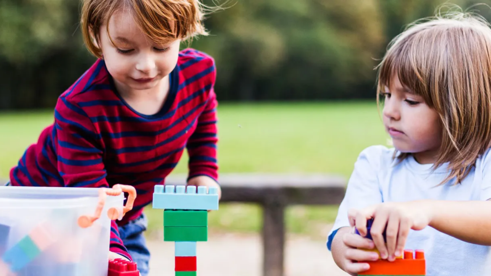Children playing with blocks outside. m