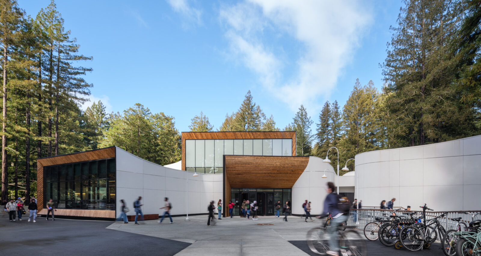 Kresge building with students walking and biking